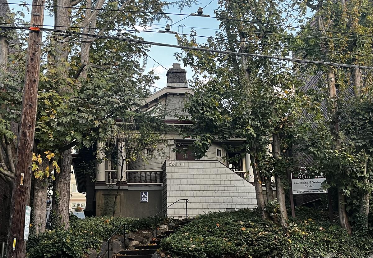 Capitol Hill Offices — 226 Summit Ave E exterior, a 1917 Craftsman home surrounded by mature trees
