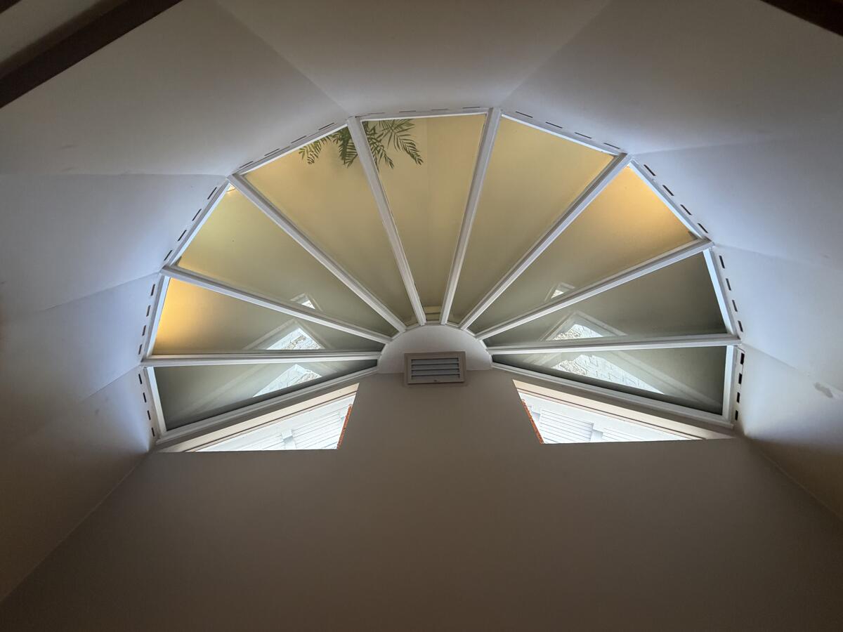 Original fan-shaped dormer window on the upper floor letting in natural light